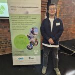 APEX 2024 Leon Lang Young engineer Leon Lang of WEL Networks stands infront of APEX banner